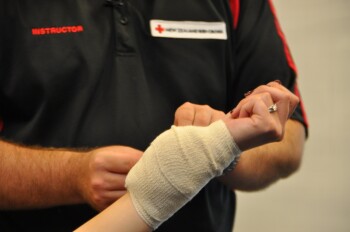 Learning first aid bandaging techniques